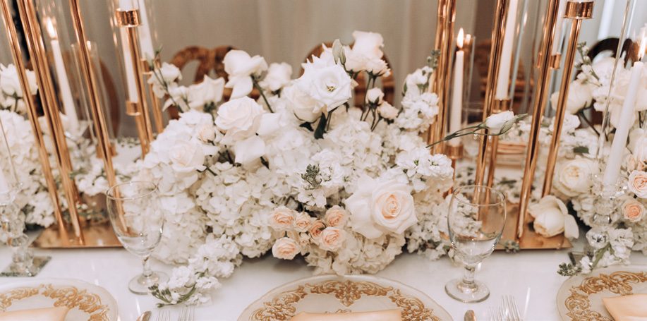 White wedding flowers and rose-gold table decor